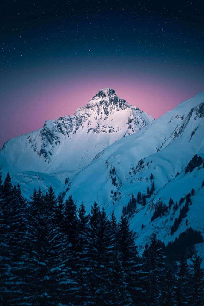 Beschneiter Berggipfel bei Sternennacht